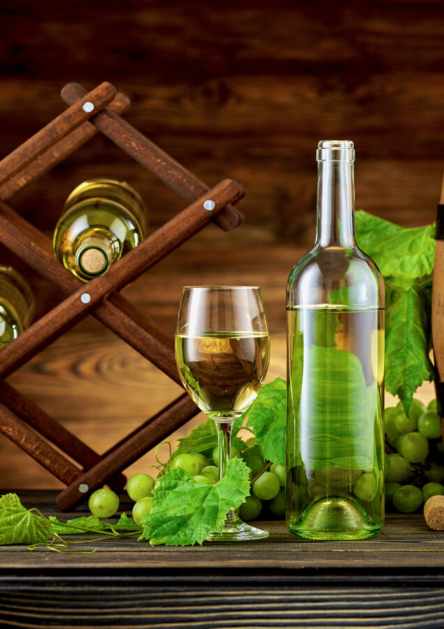 Wine bottle and glasses with wooden barrel on the table